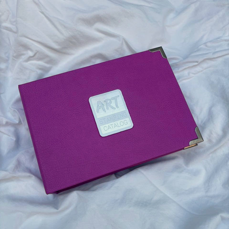 Purple folder for nail art stamping plates with a visible brand logo on a white textured surface