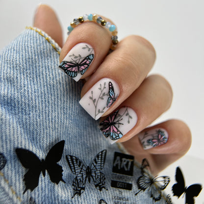 Nails with butterfly design on a denim fabric background
