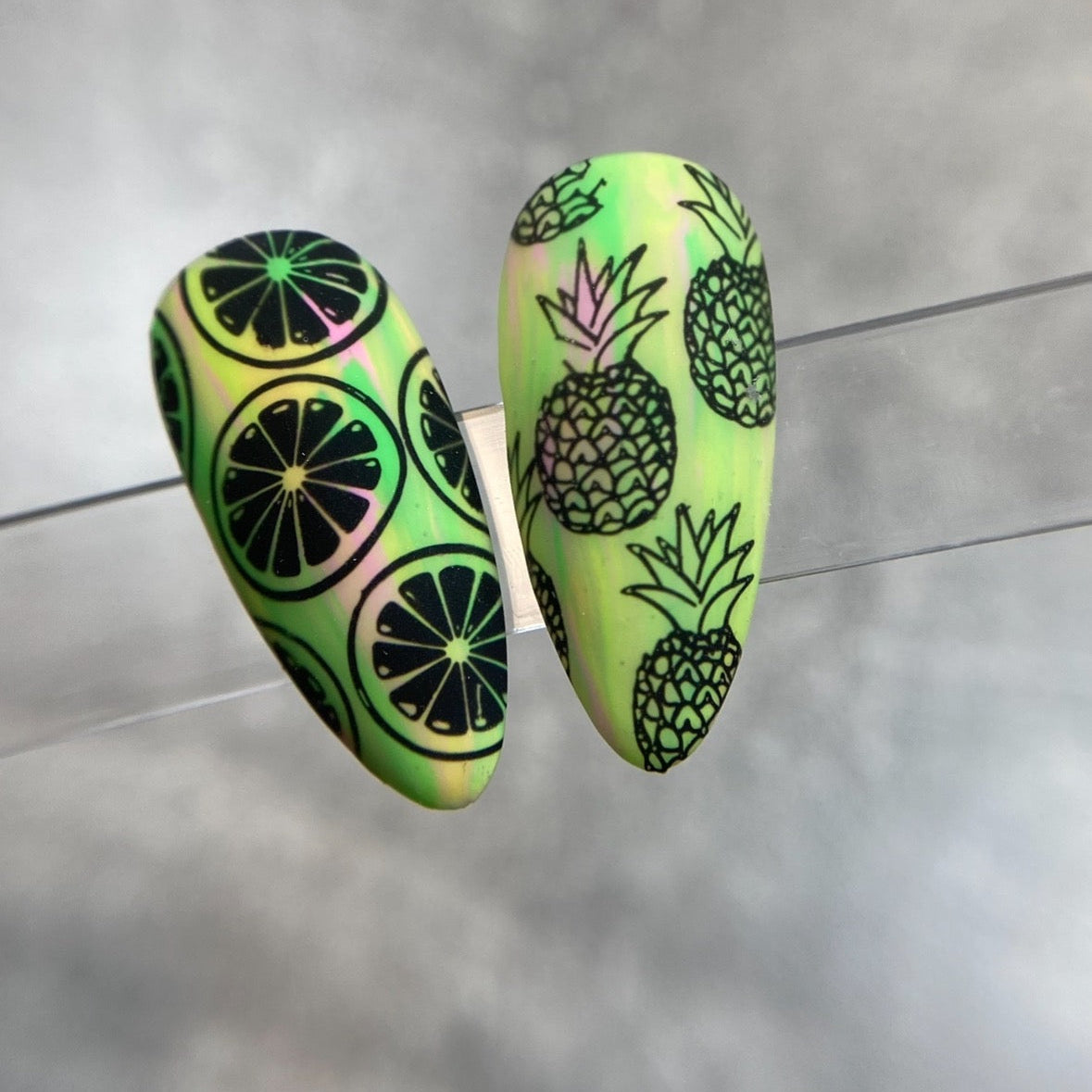 Nail art with pineapple and lime designs on a nail tips
