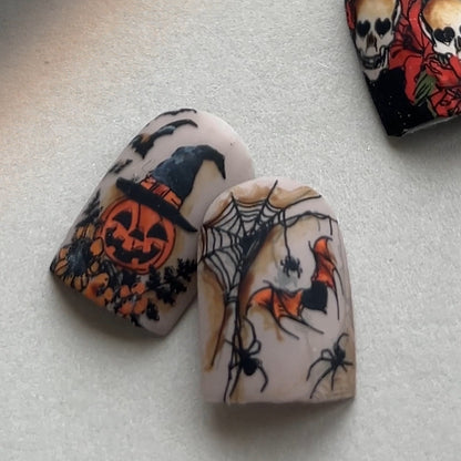 Decorative Halloween-themed nail art on a white surface