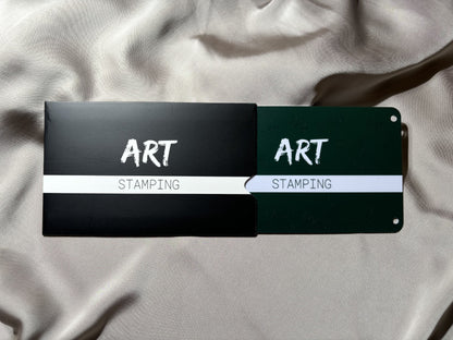 Unpacking nail art stamping plats with the brand name ART Stamping on package and plate, positioned on a textured fabric surface.