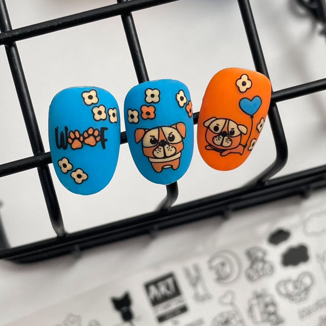 Three nail art designs on a black grid background