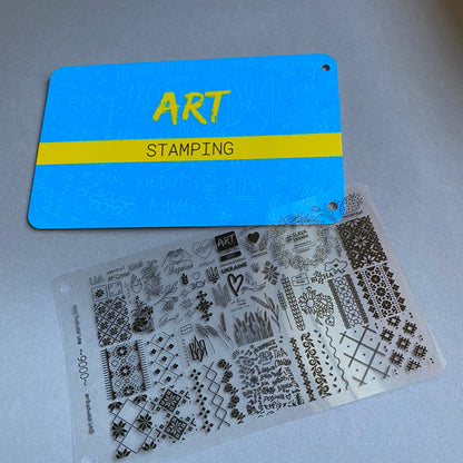 Art stamping plate with clear stamp set on a gray surface