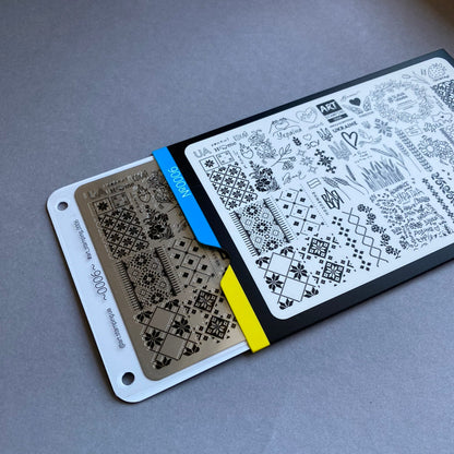 Two stencils with geometric patterns on a gray surface