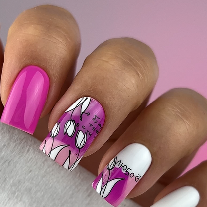 Nail art with pink, white, and purple design on a gradient background