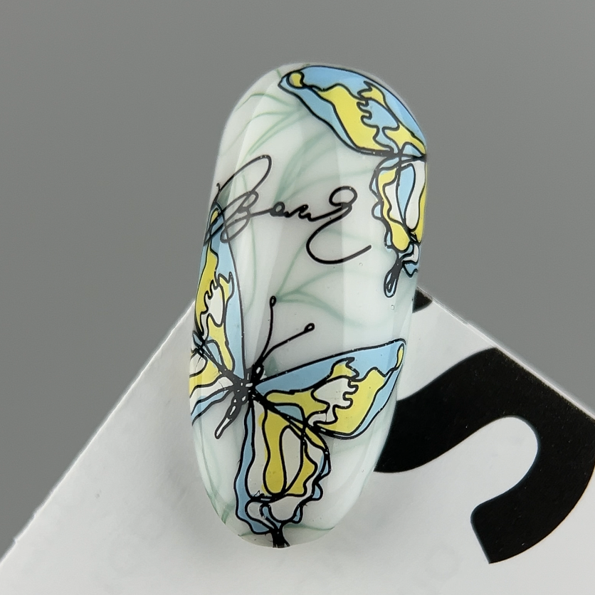 Decorative die with a blue and yellow butterfly design on a gray background